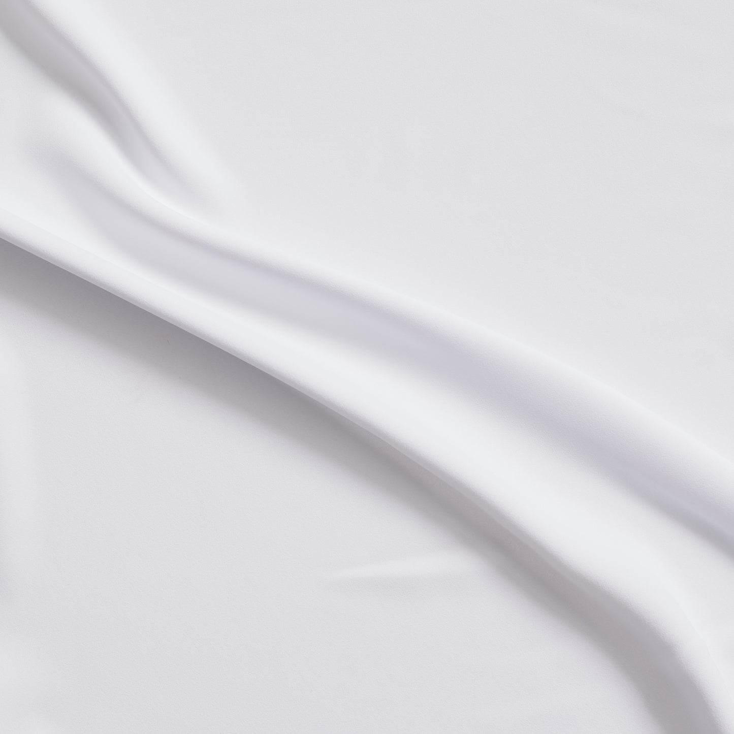 sensation presenting the white color version of a medium weight silk faille-like pure polyester with weft natural stretch and fluid drape