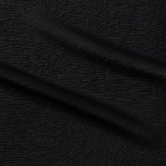 silhouette showing splaying the black color version of a sheer semi-opaque pure rayon crinkle georgette with fluid drape suitable for dresses skirts pants or tops