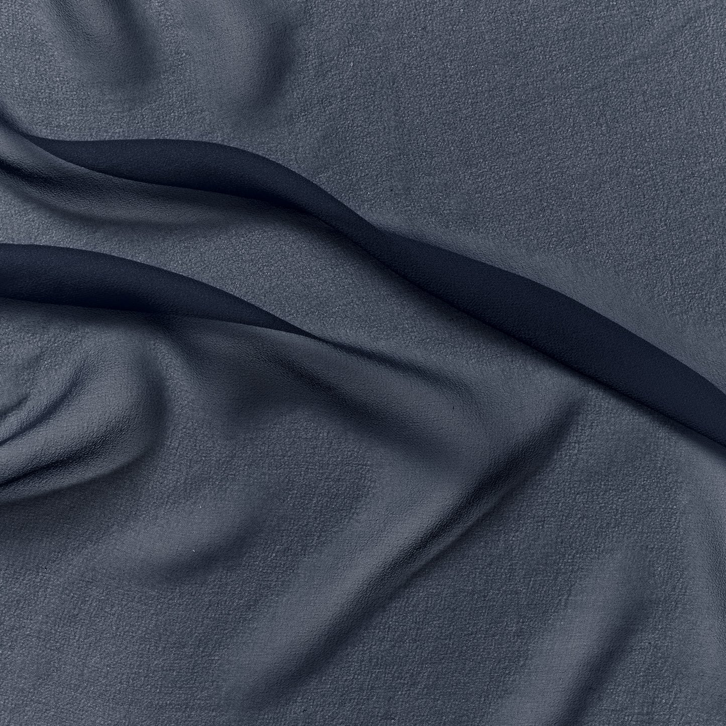silk georgette presenting the navy color version of a Lightweight sheer floaty pure silk with excellent drape great for layering and gathering