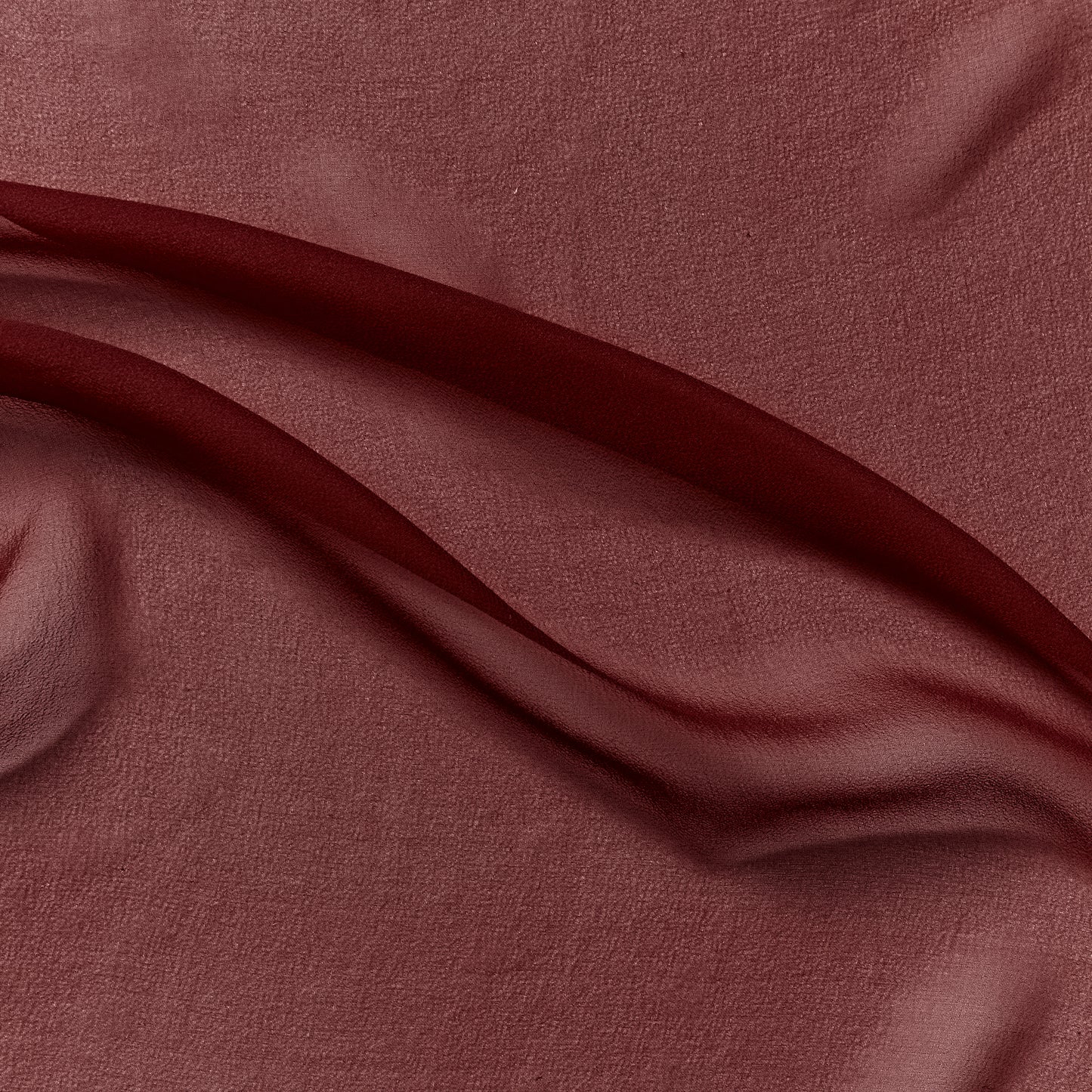 silk georgette exhibiting the ruby color version of a Lightweight sheer floaty pure silk with excellent drape great for layering and gathering