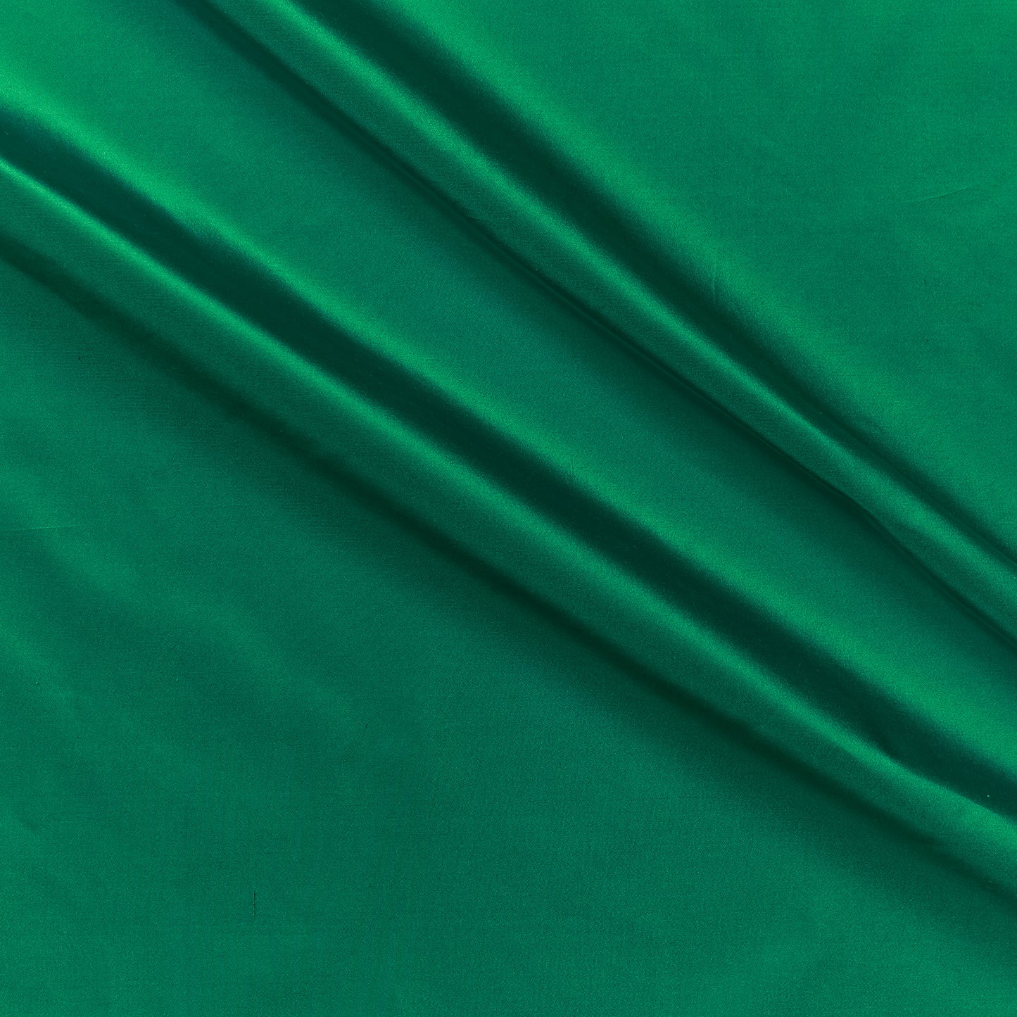 silk taffeta presenting the emerald green color version of a smooth crisp pure silk with good drape