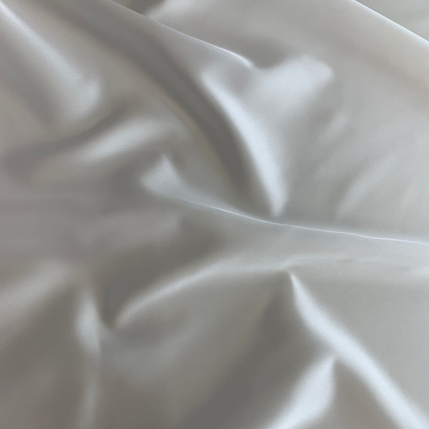 Presenting Stella heavy stretch satin a ivory colored polyester Microfiber and Spandex blended fabric