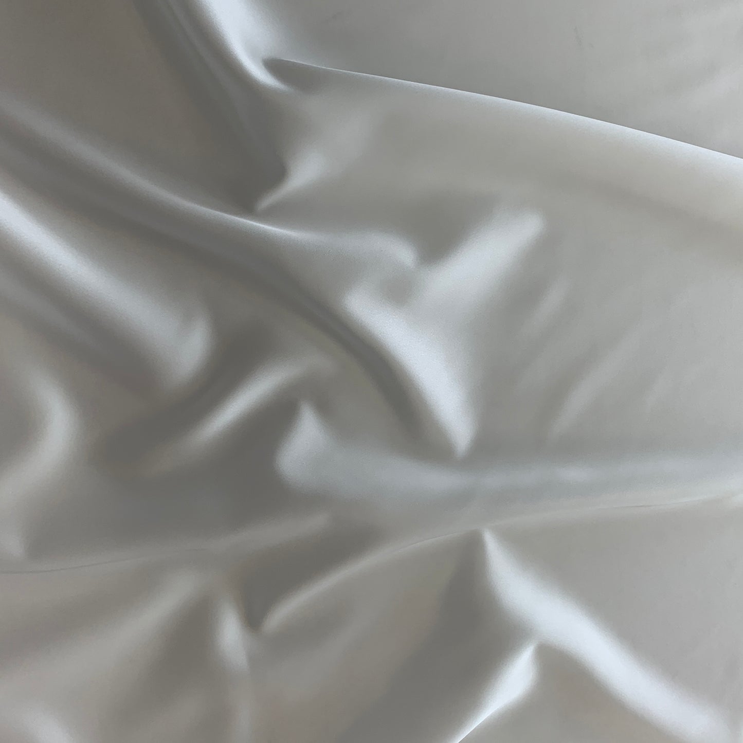 Presenting Stella heavy stretch satin a ivory colored polyester Microfiber and Spandex blended fabrics