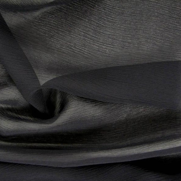 silhouette showing the black color version of a sheer semi-opaque pure rayon crinkle georgette with fluid drape closeup