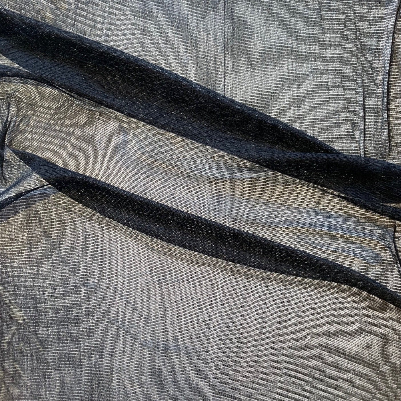 vapour presenting the black color variant of a soft sheer breathable light weight matte pure silk tulle featuring natural silk sheen