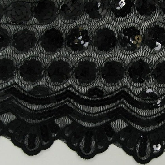 Showing in closeup vegas a black colored sequins in regular spots black sheer polyester mesh base featuring a double scalloped edge with sequins
