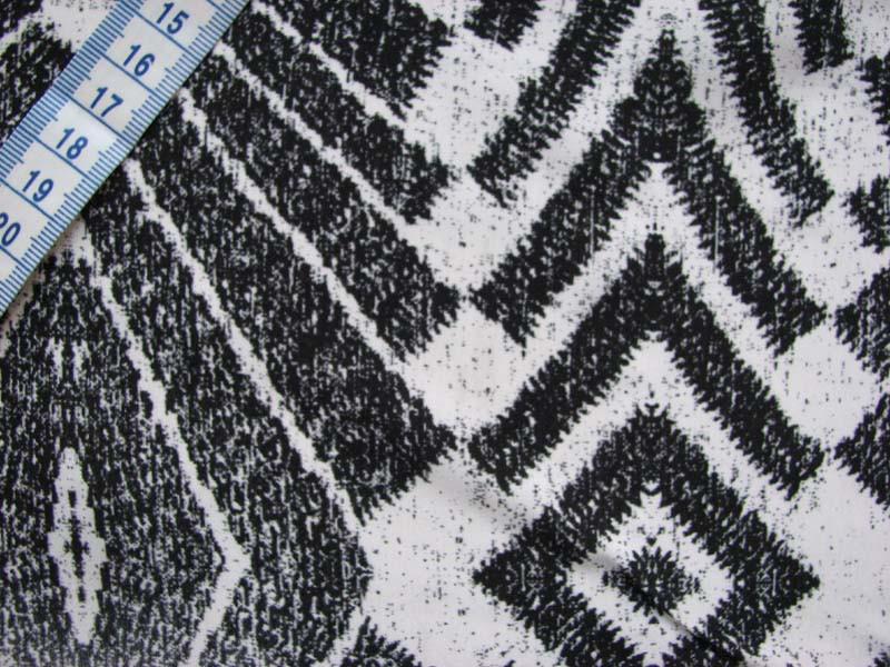 warrior presenting a black silk and viscose blend with warp print in close up