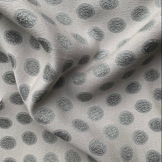 scramble showing the silver color version of a medium weight polyester blend featuring metallic spots with lurex thread and good drape