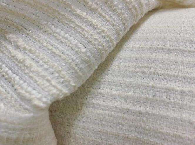 chanel exhibiting the ivory color version of a sophisticated textured tweed bouclé pure polyester with lurex thread shown folded over