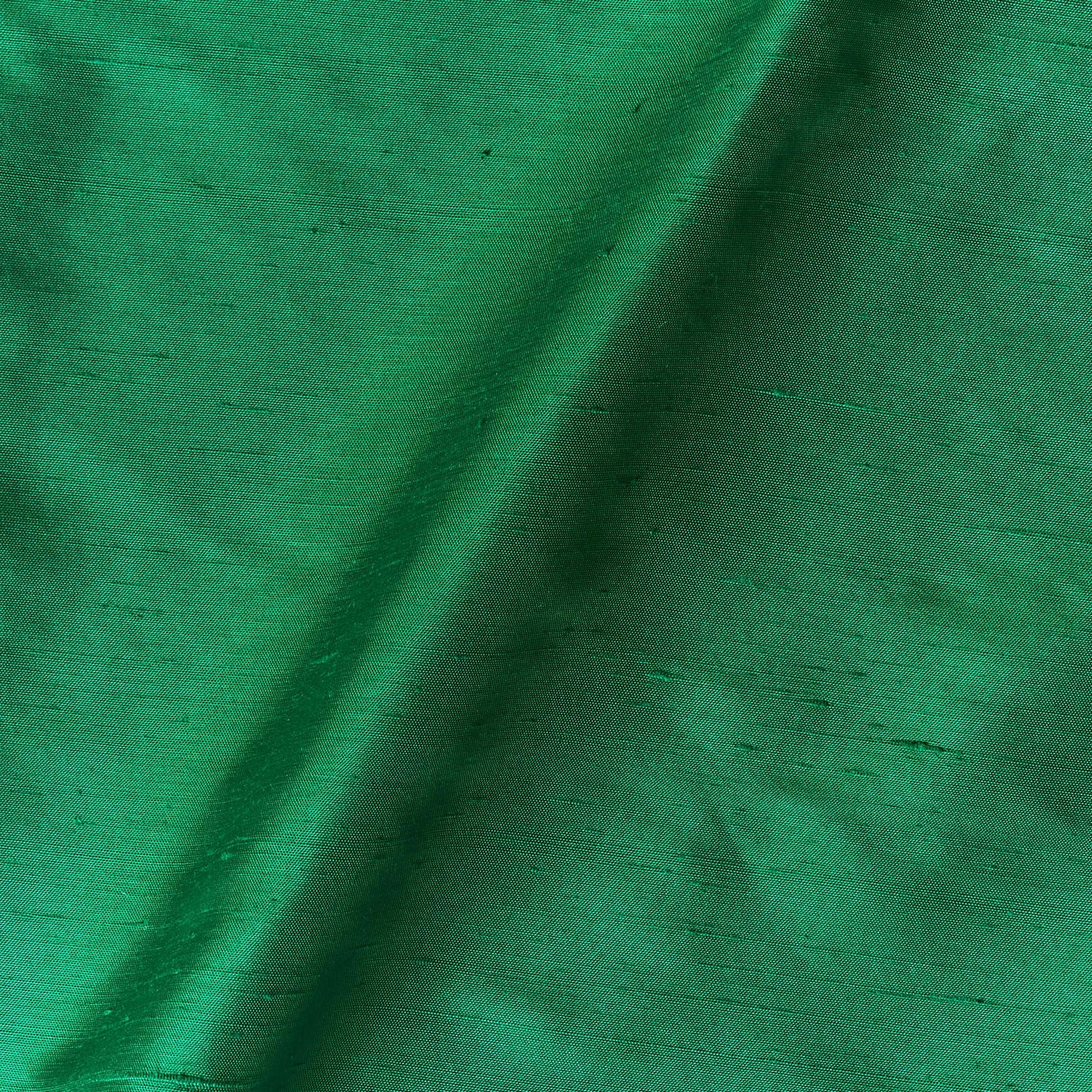 Presenting Bohai Dupion pure silk in an emerald shade with moderate drape