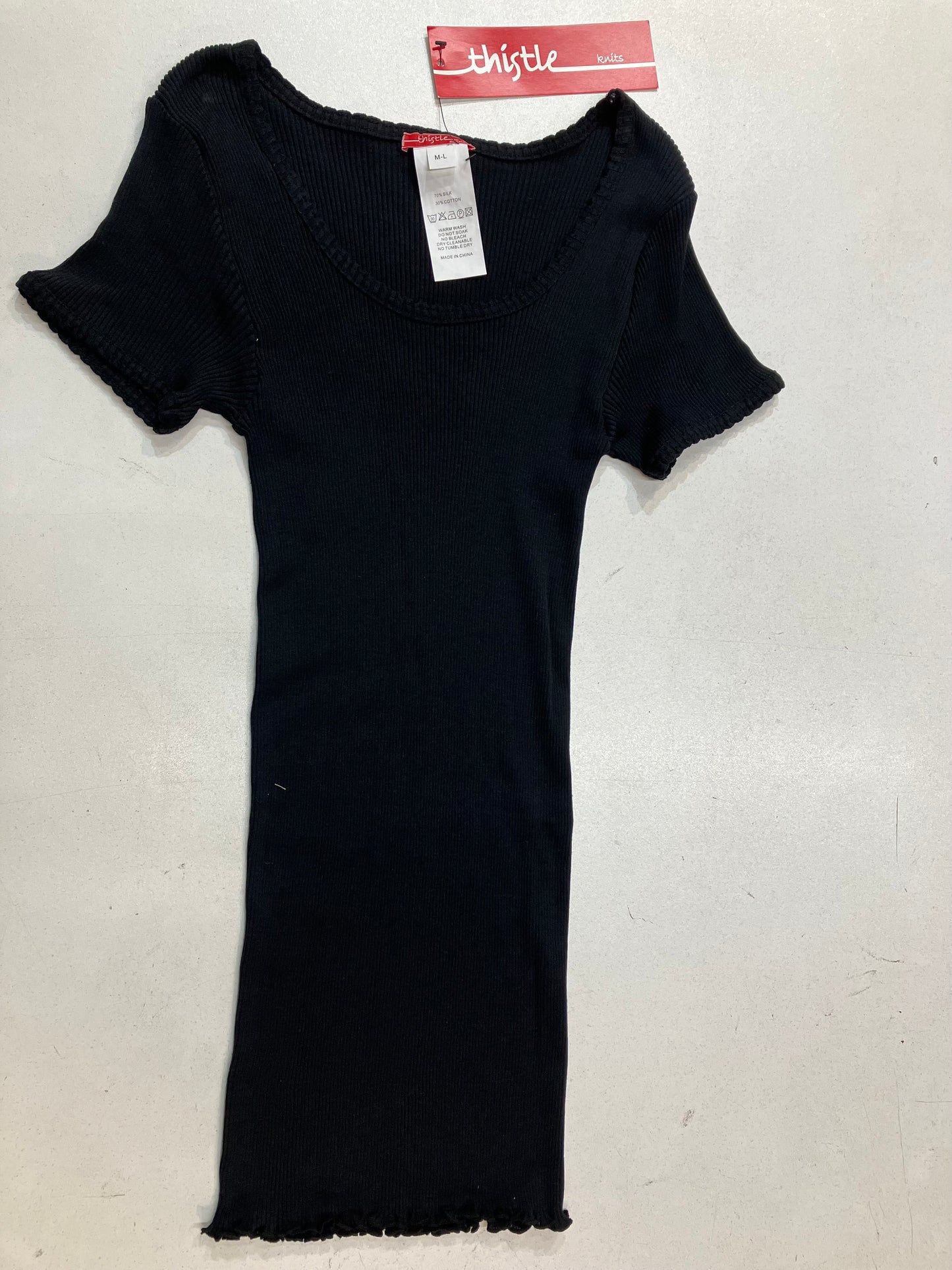 Presenting a black colored silk and cotton cotton rib knit top with cap sleeves