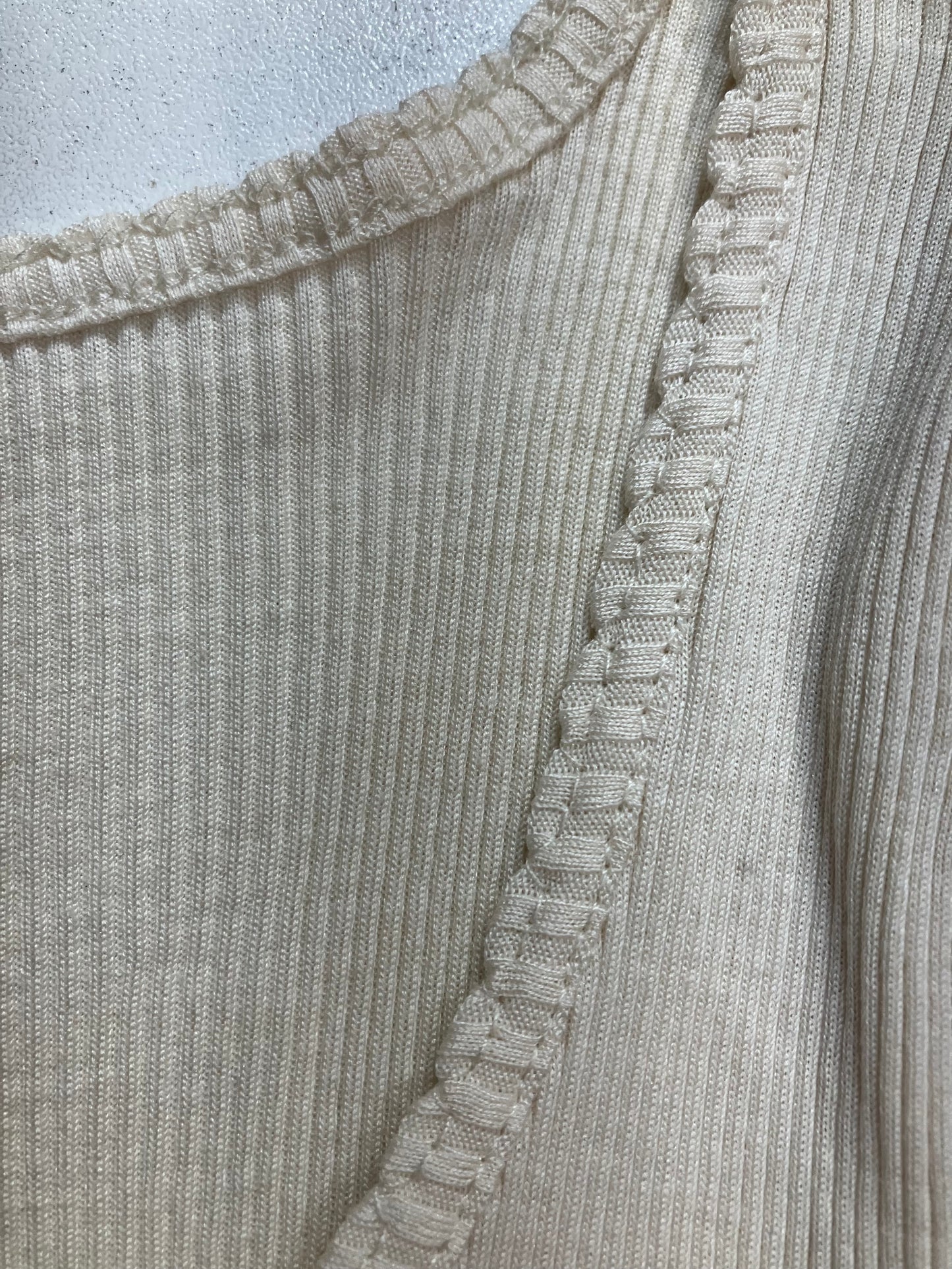 Presenting a closeup of the neckline of a silk and cotton cotton rib knit top 