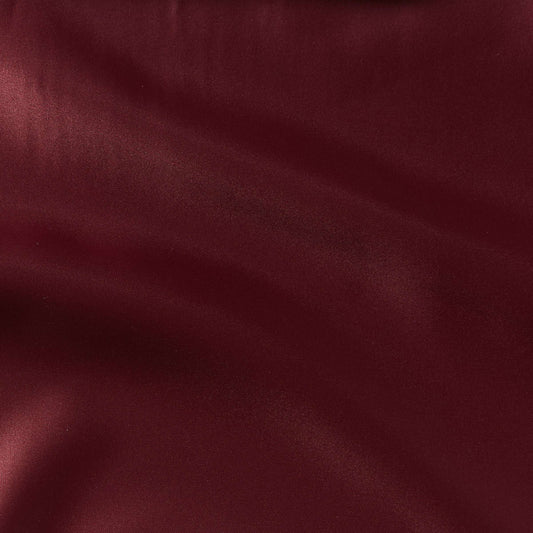 countess presenting the burgundy color version of a crisp satin pure polyester fabric with moderate drape