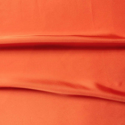 Deluxe presenting the coral color version of a satin chiffon silk like pure polyester with fluid drape