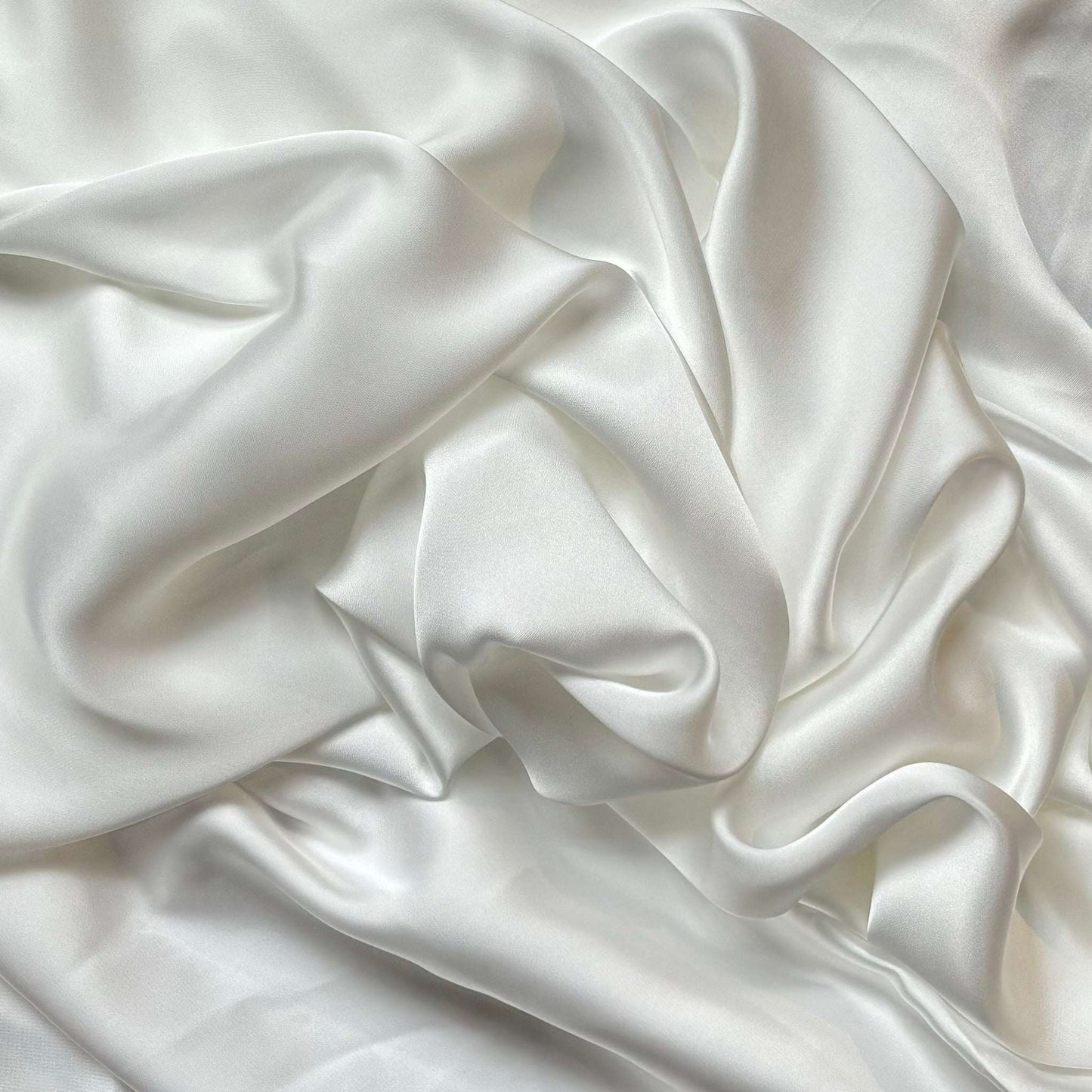 Deluxe presenting the ivory color version of a satin colored chiffon silk like pure polyester with fluid drape