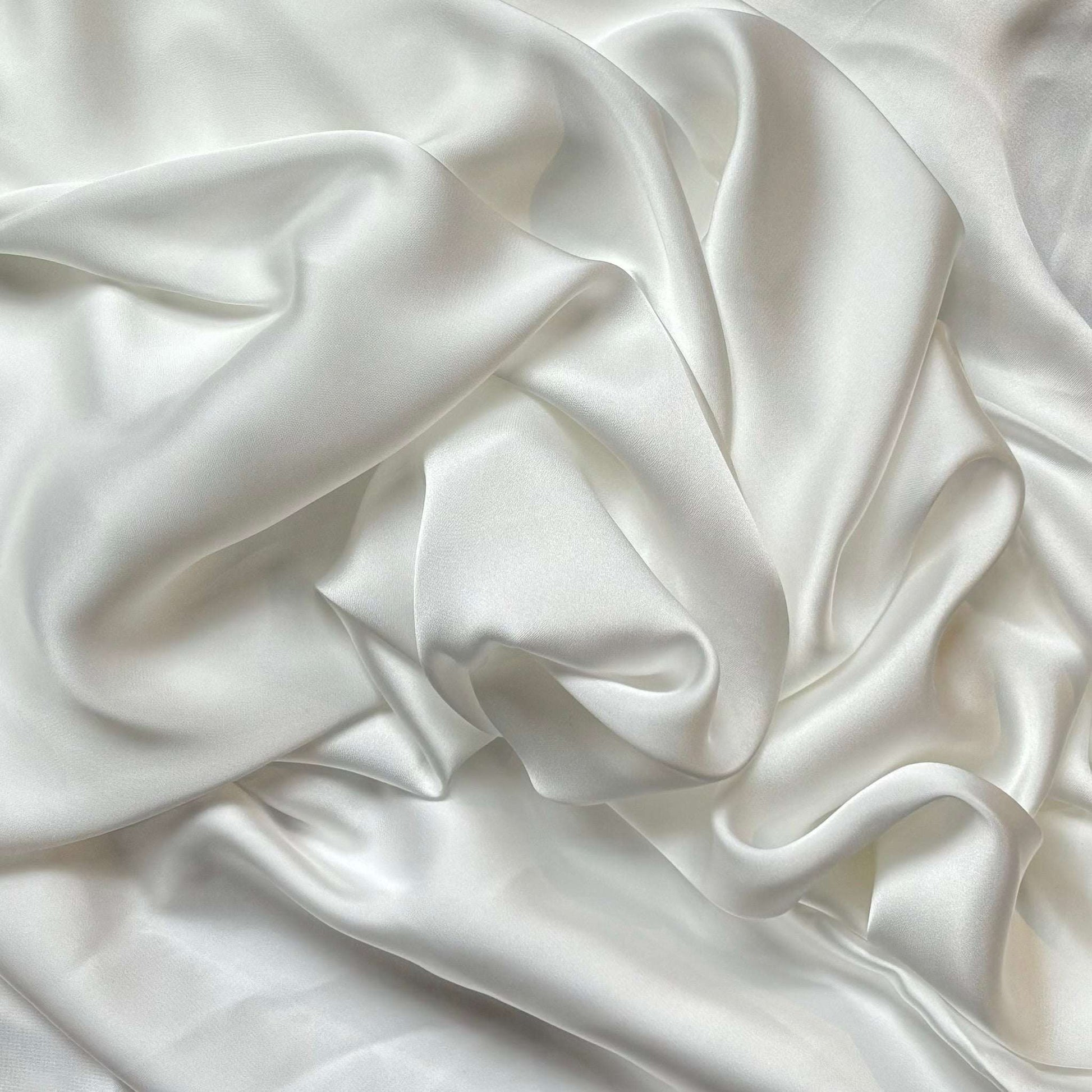 Deluxe presenting the ivory color version of a satin colored chiffon silk like pure polyester with fluid drape