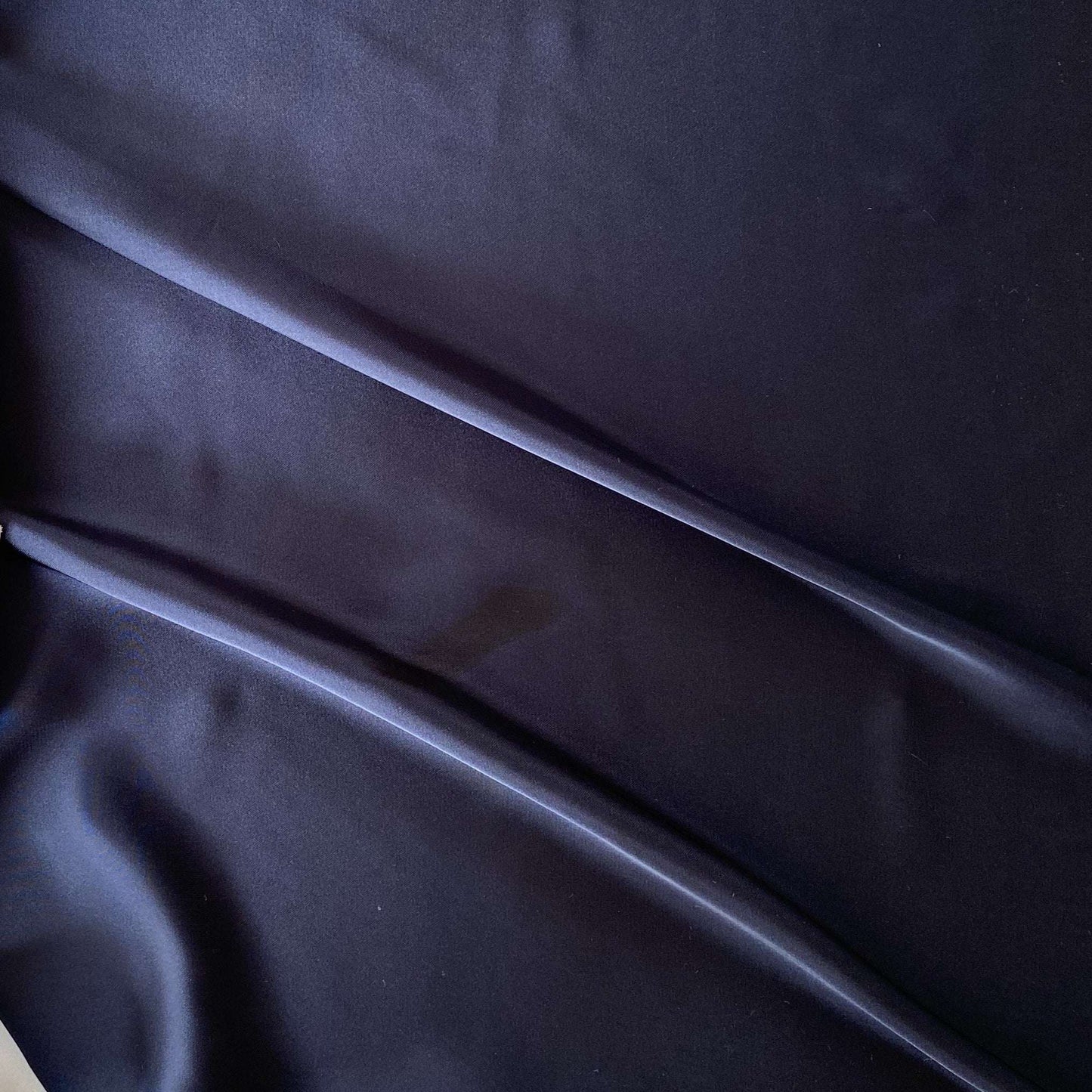 Deluxe presenting the navy color version of a satin chiffon silk like pure polyester with fluid drape