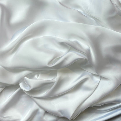 Deluxe displaying the white color version of a satin colored chiffon silk like pure polyester with fluid drape