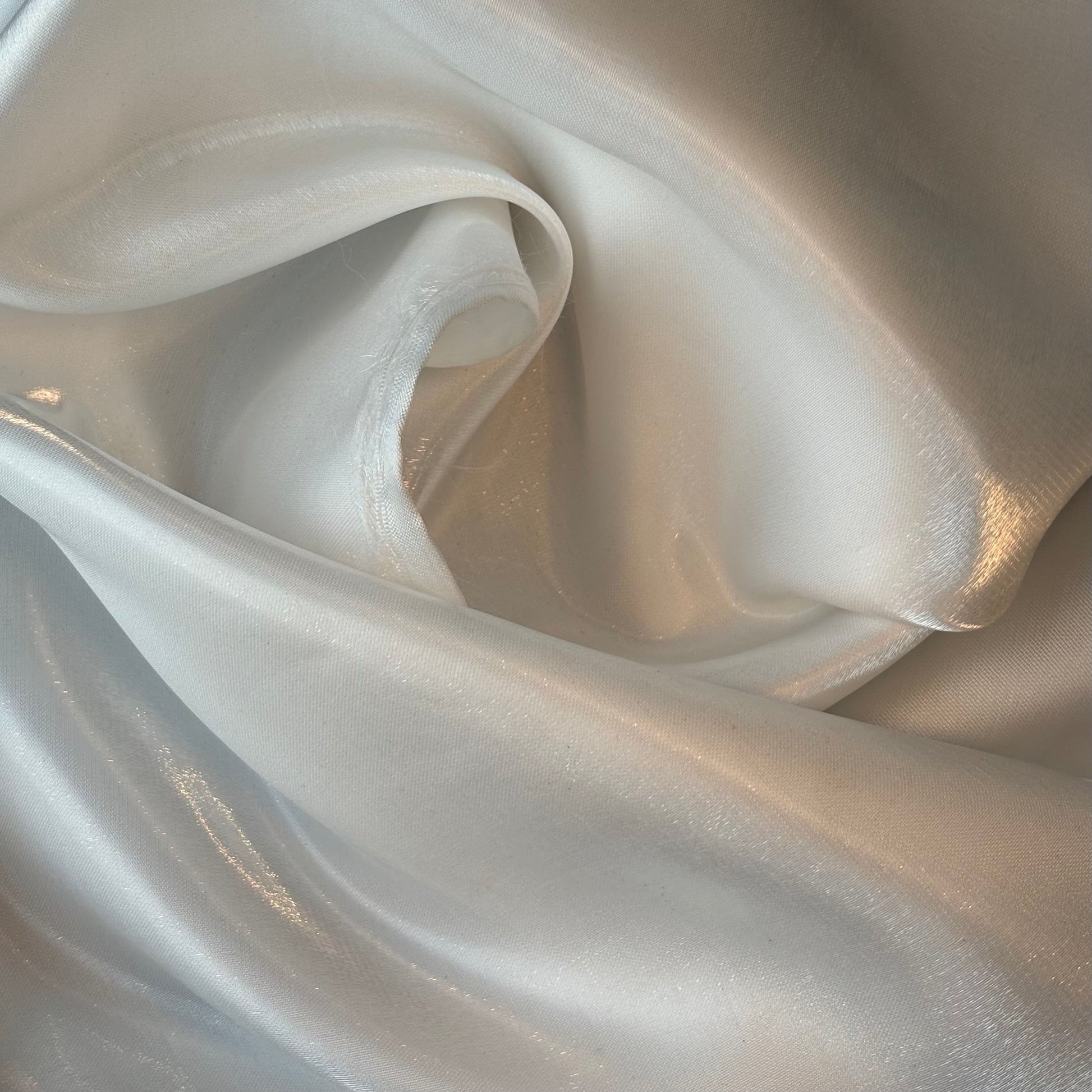 Displaying Glace a pure polyester bridal or evening wear fabric with a mirror finish in a ivory colour