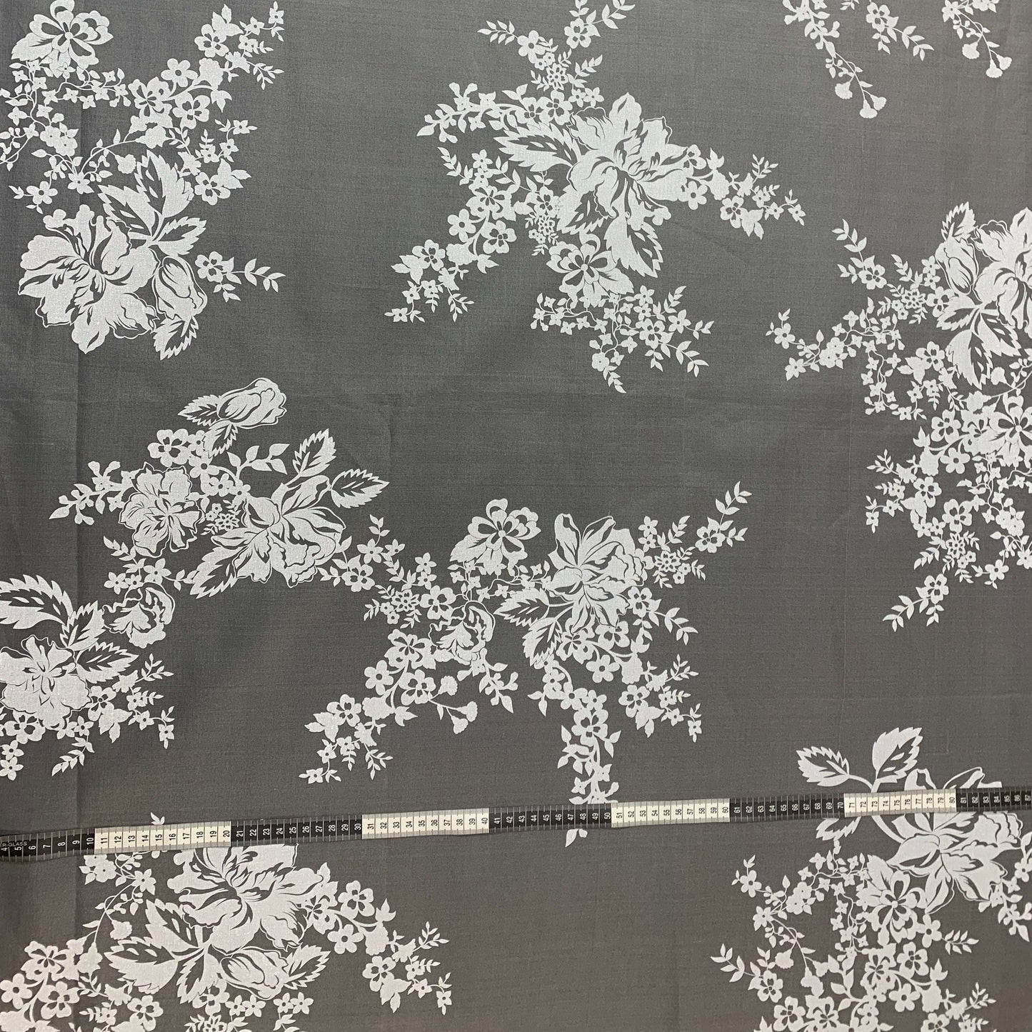 Presenting rhapsody which is a white floral print on sheer ivory pure silk organza showing with a rule for scale