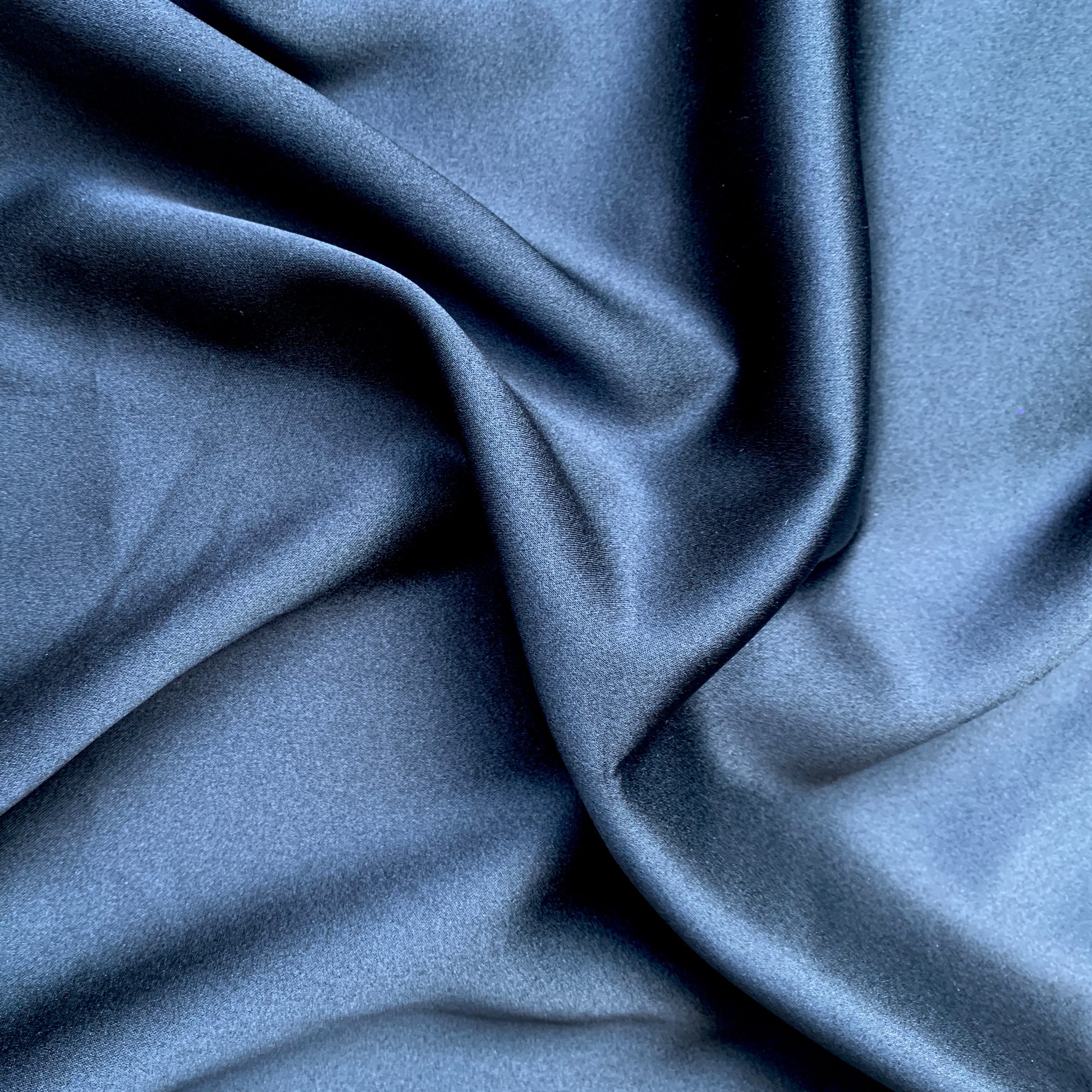 stretch silk satin featuring the black color version of a silk and lycra blend with great drape