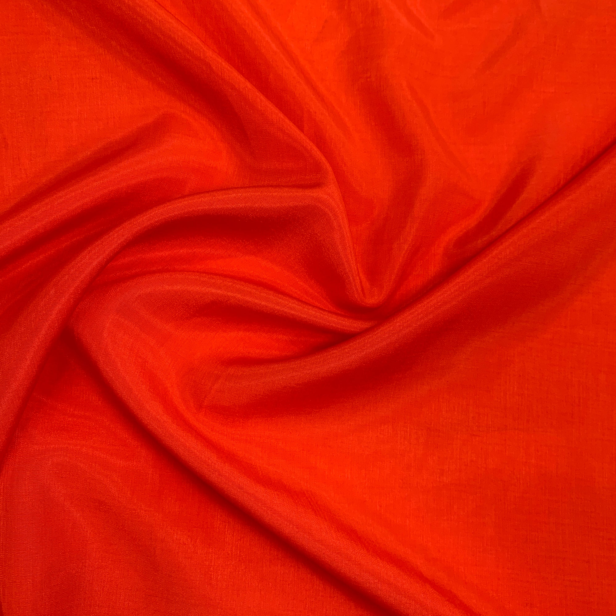 Displaying Linus a fire colored rayon and polyester blend with a sateen sheen