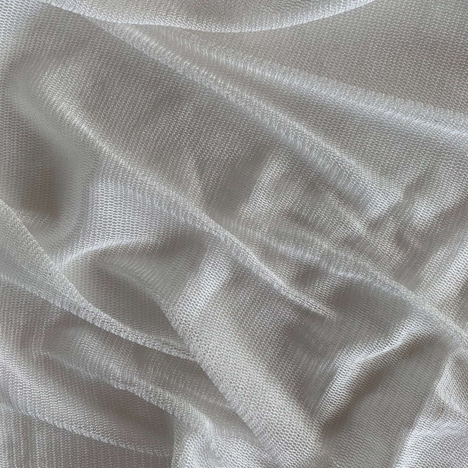 vapour showing the natural color variant of a soft sheer breathable light weight matte pure silk tulle with natural silk sheen