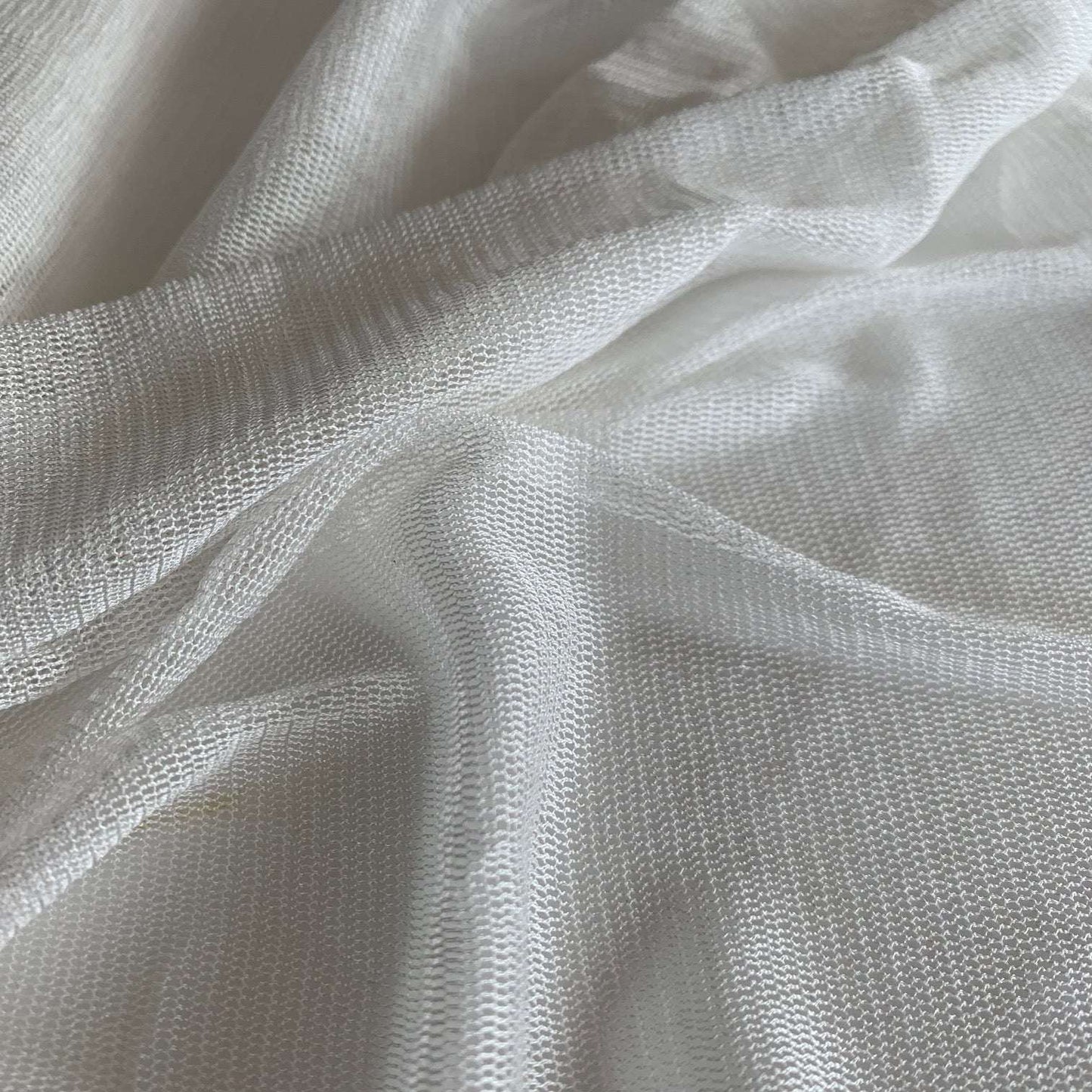 vapour showing the natural color variant of a soft sheer breathable light weight matte pure silk tulle with natural silk sheen