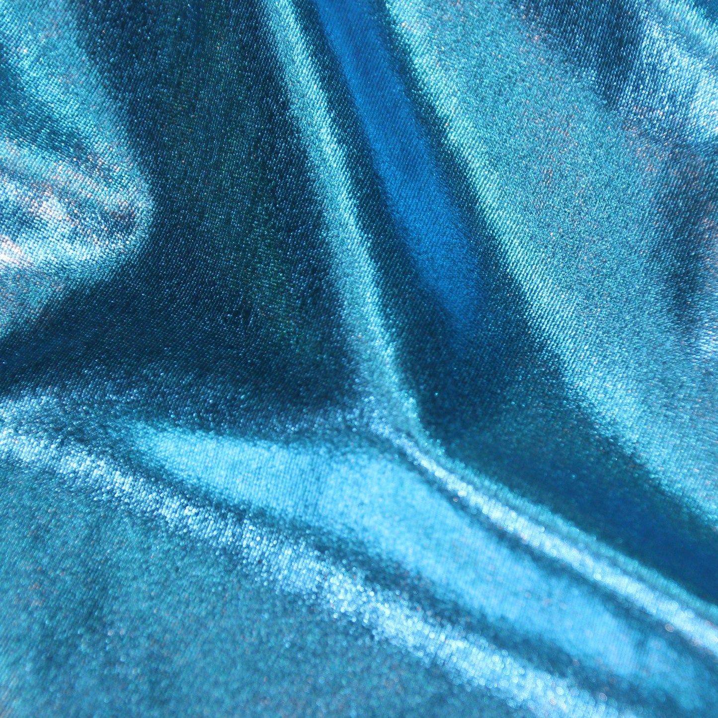 Metallica presenting the Turquoise color version of a stretch shiny polyester and spandex blend with good drape