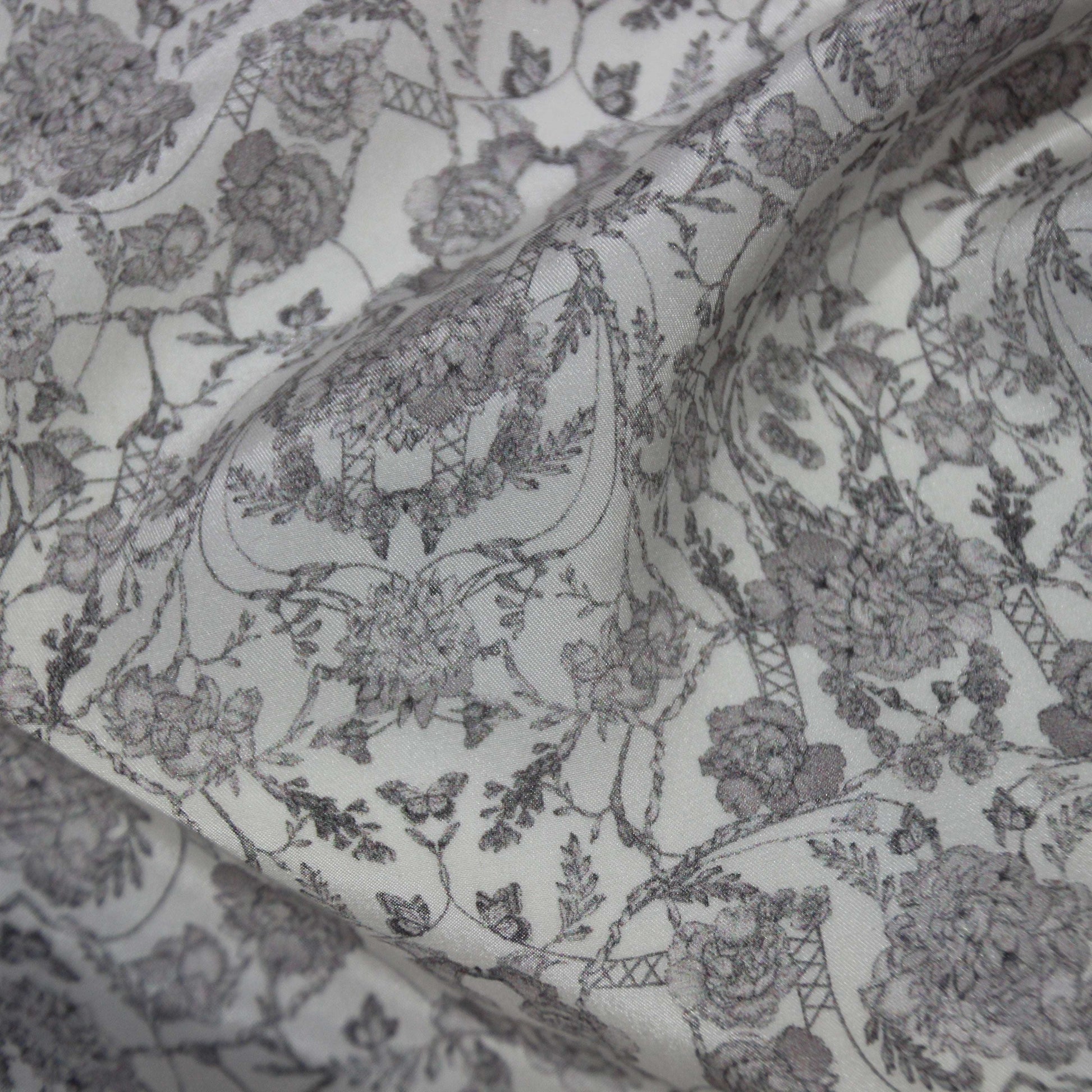 Exhibiting Filigree a gray toned floral print on pure silk