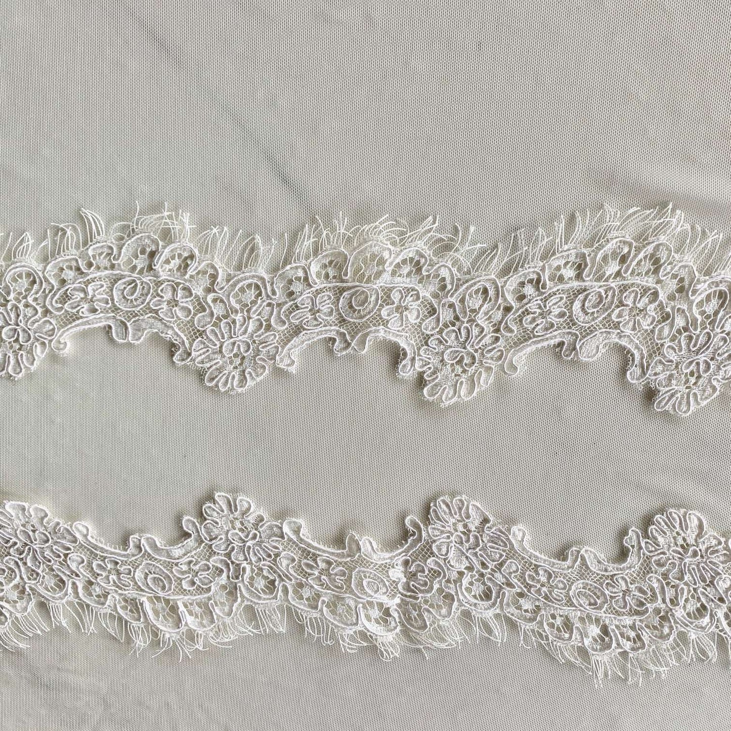 Presenting ingrid an ivory colored Scalloped rayon and nylon lace with corded embroidery and eyelash on trim