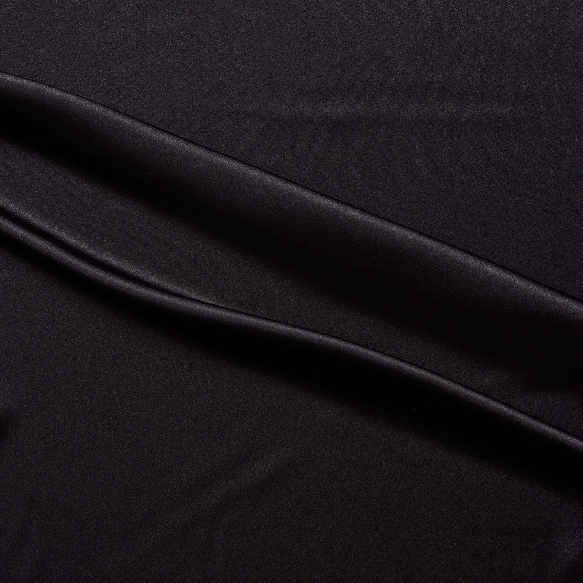 lola presenting the black color version of a stretch light weight soft satin polyester with spandex