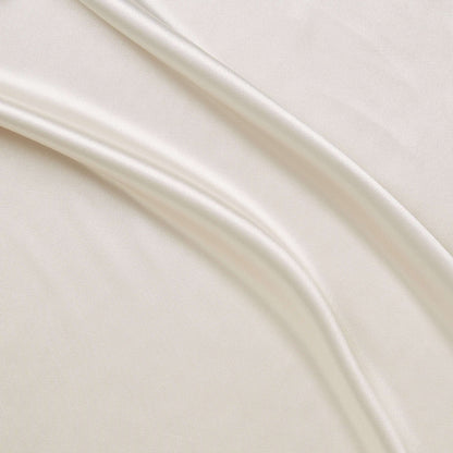 lola presenting the ivory color versions of a stretch light weight soft satin polyester with spandex