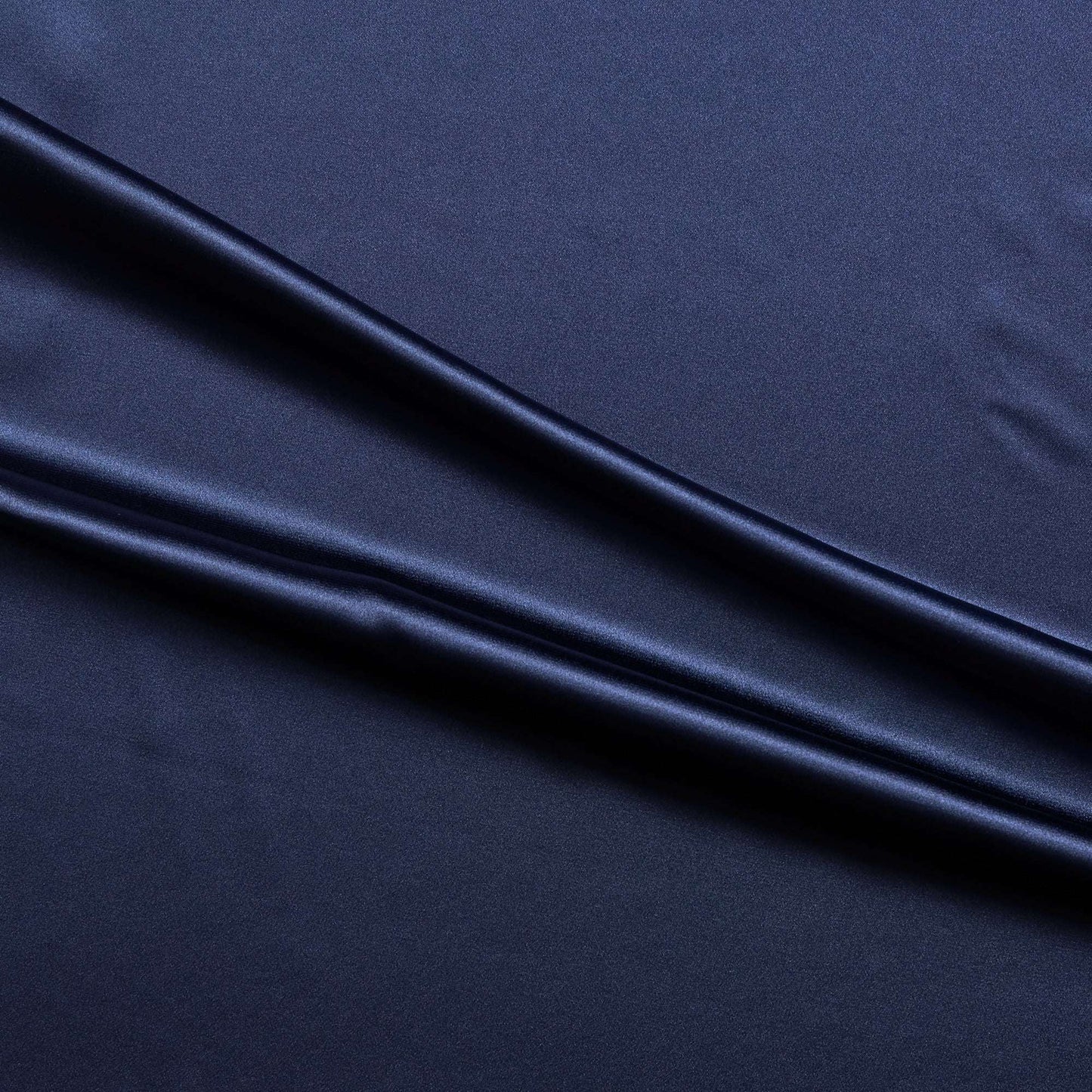 lola presenting the navy color version of a stretch light weight soft satin polyester with spandex