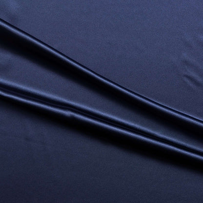 lola presenting the navy color version of a stretch light weight soft satin polyester with spandex