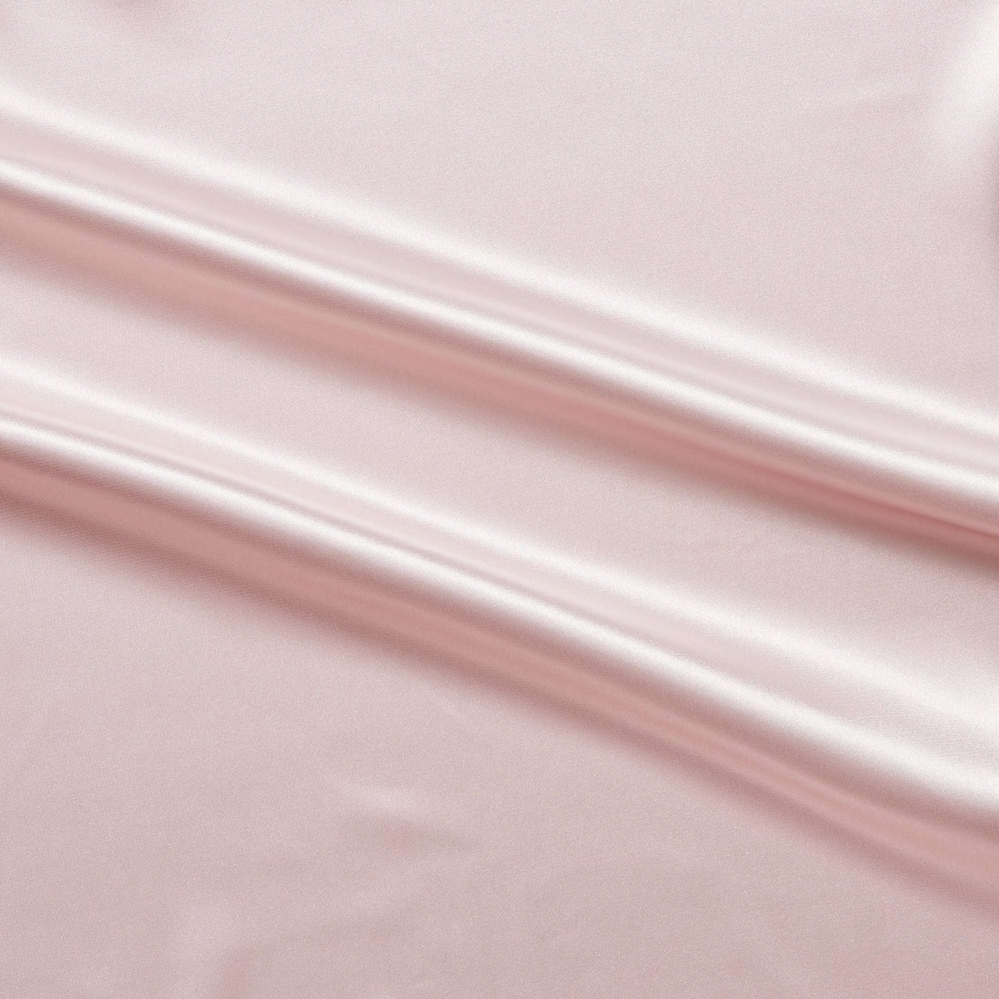 lola presenting the pale pink color version of a stretch light weight soft satin polyester with spandex