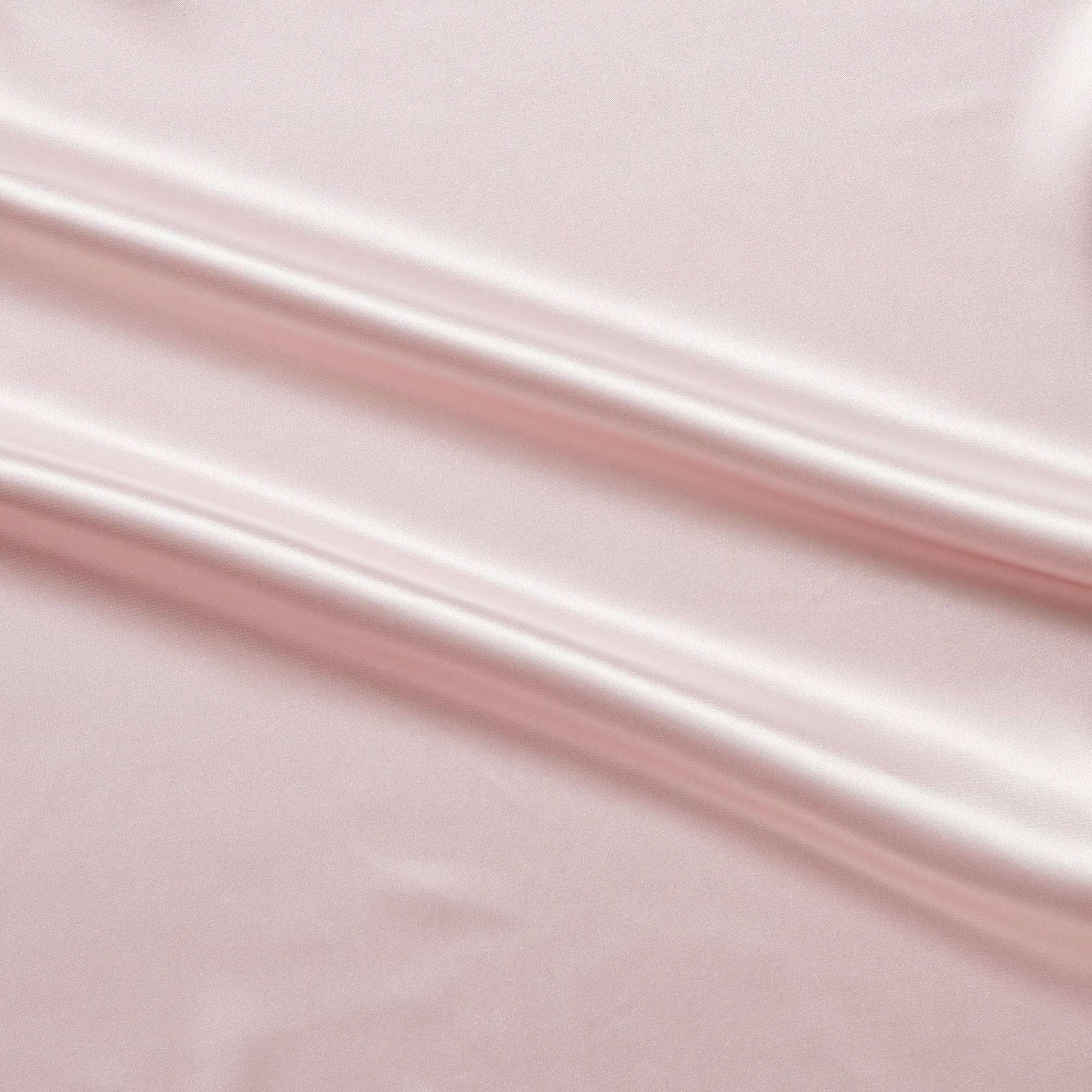 lola presenting the pale pink color version of a stretch light weight soft satin polyester with spandex