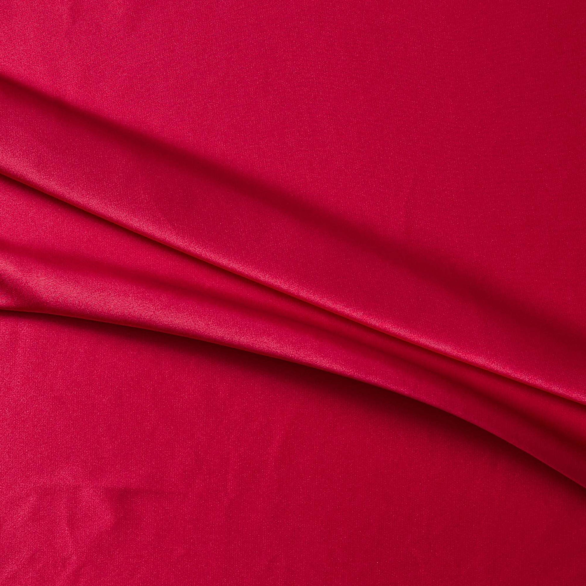 lola presenting the red color version of a stretch light weight soft satin polyester with spandex