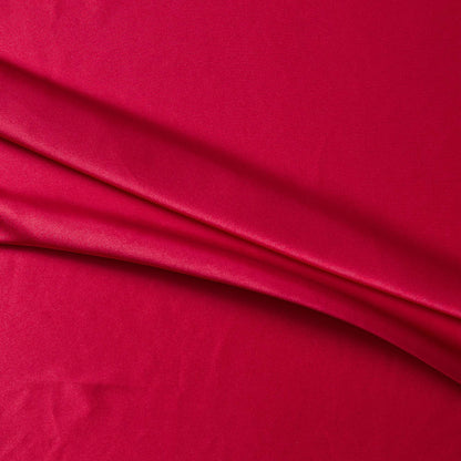 lola presenting the red color version of a stretch light weight soft satin polyester with spandex