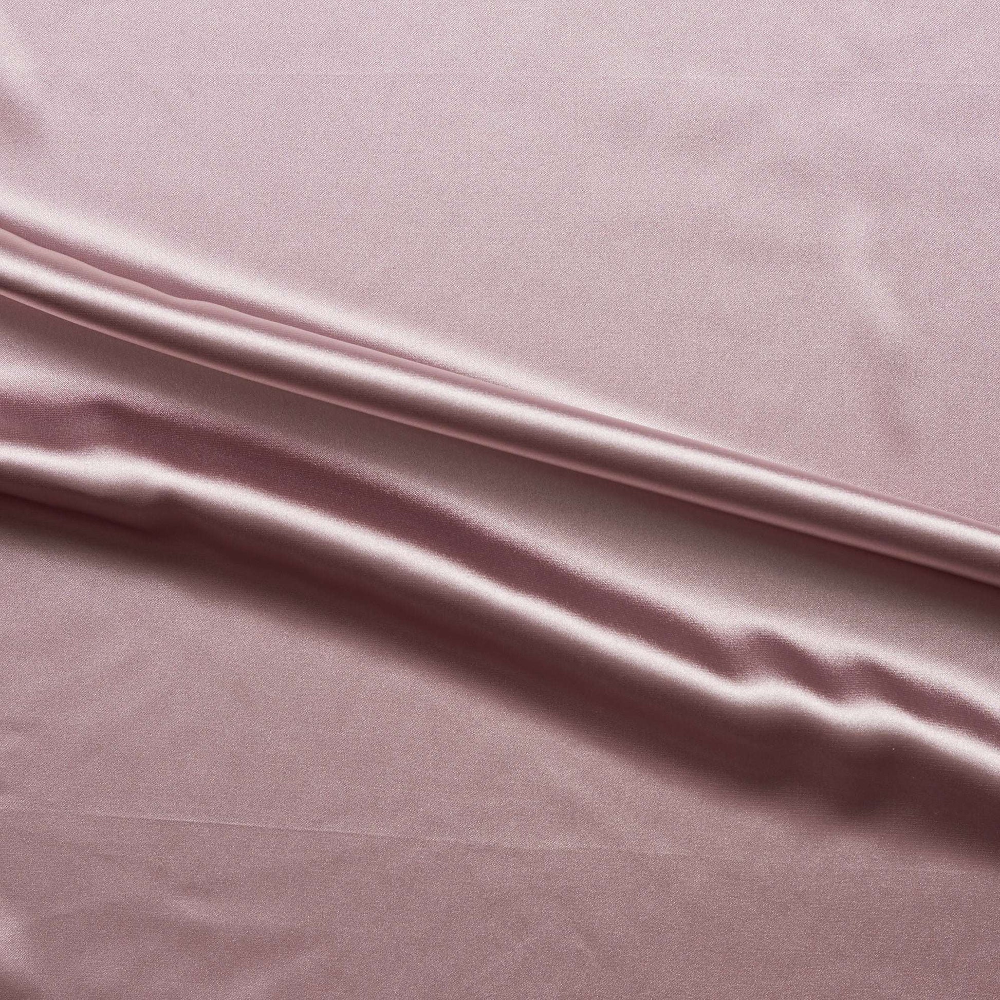 lola presenting the tearose color version of a stretch light weight soft satin polyester with spandex