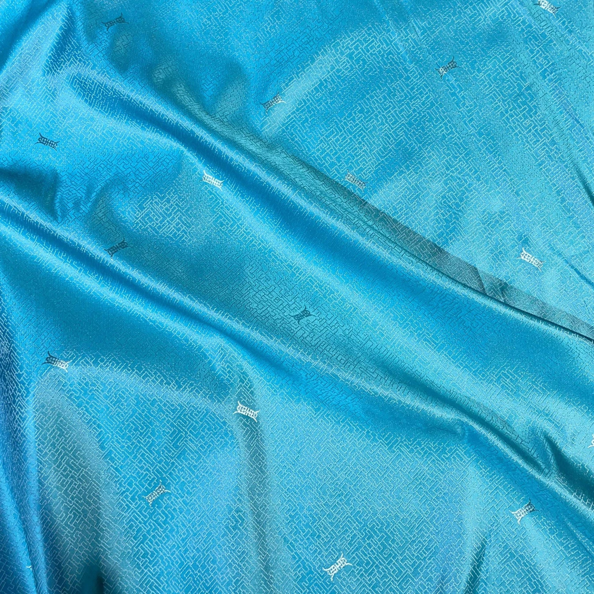 ming presenting the aqua color version of a silk and rayon blend featuring a Chinese inspired jacquard print featuring good drape