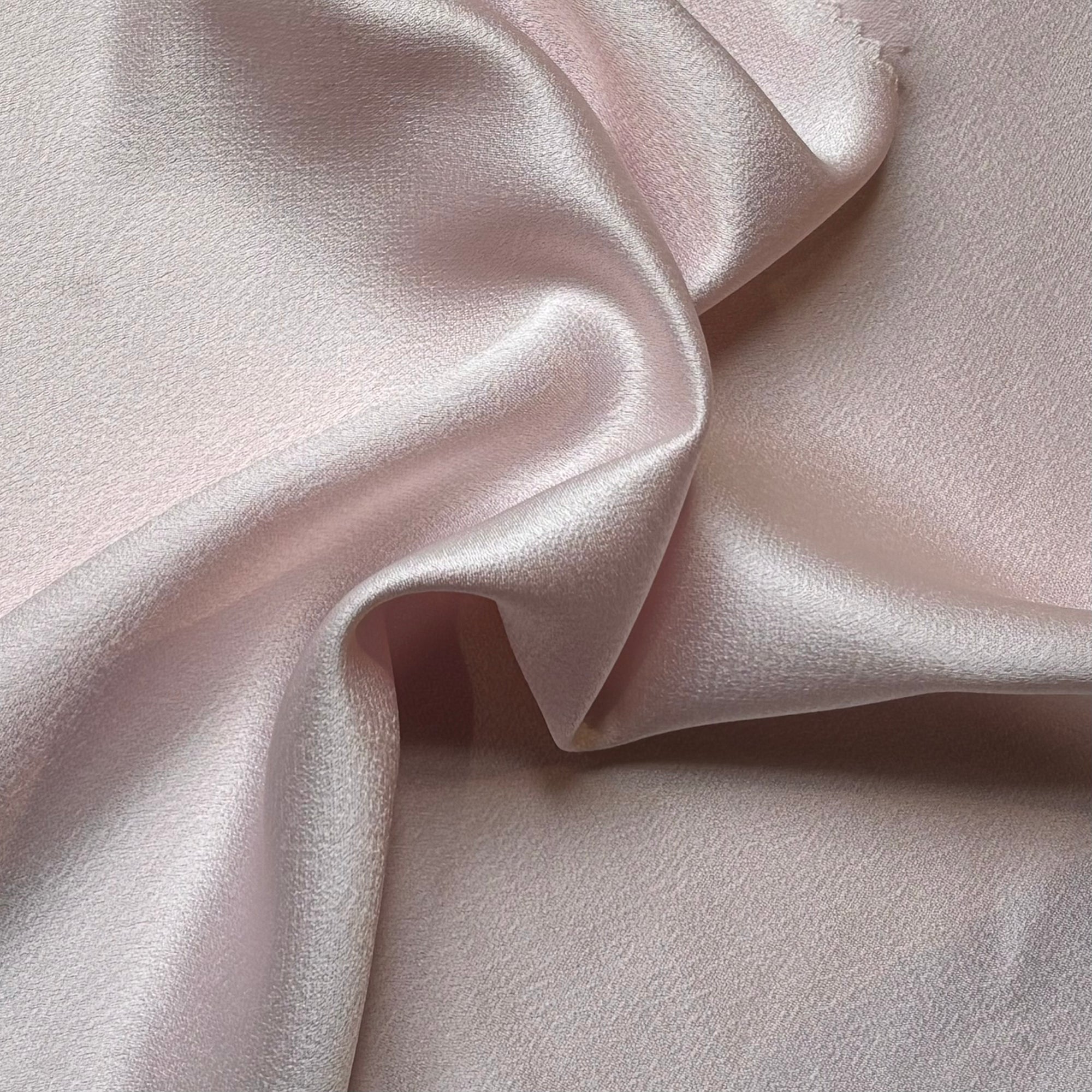 celebrity illustrating the ipale pink colored version of a polyester microfiber featuring a double sided matte face & satin back crepe with fluid drape