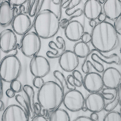 roulette showing the silver color version of a polyester and rayon abstract circular Embroidery on fine sheer mesh