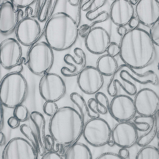roulette showing the silver color version of a polyester and rayon abstract circular Embroidery on fine sheer mesh