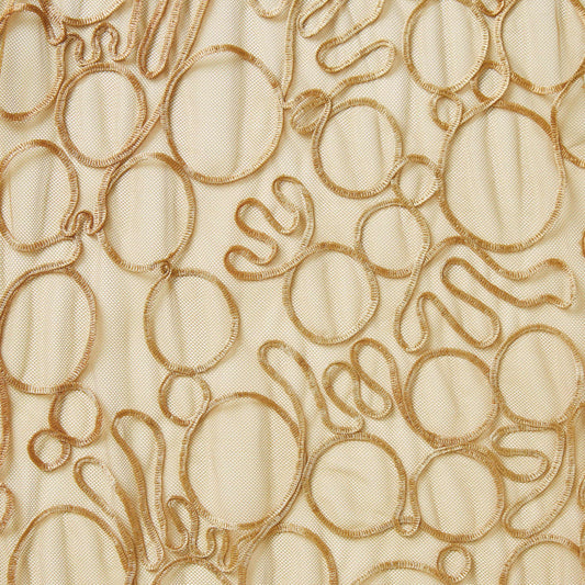 roulette showing the tan color version of a polyester and rayon abstract circular Embroidery on fine sheer mesh