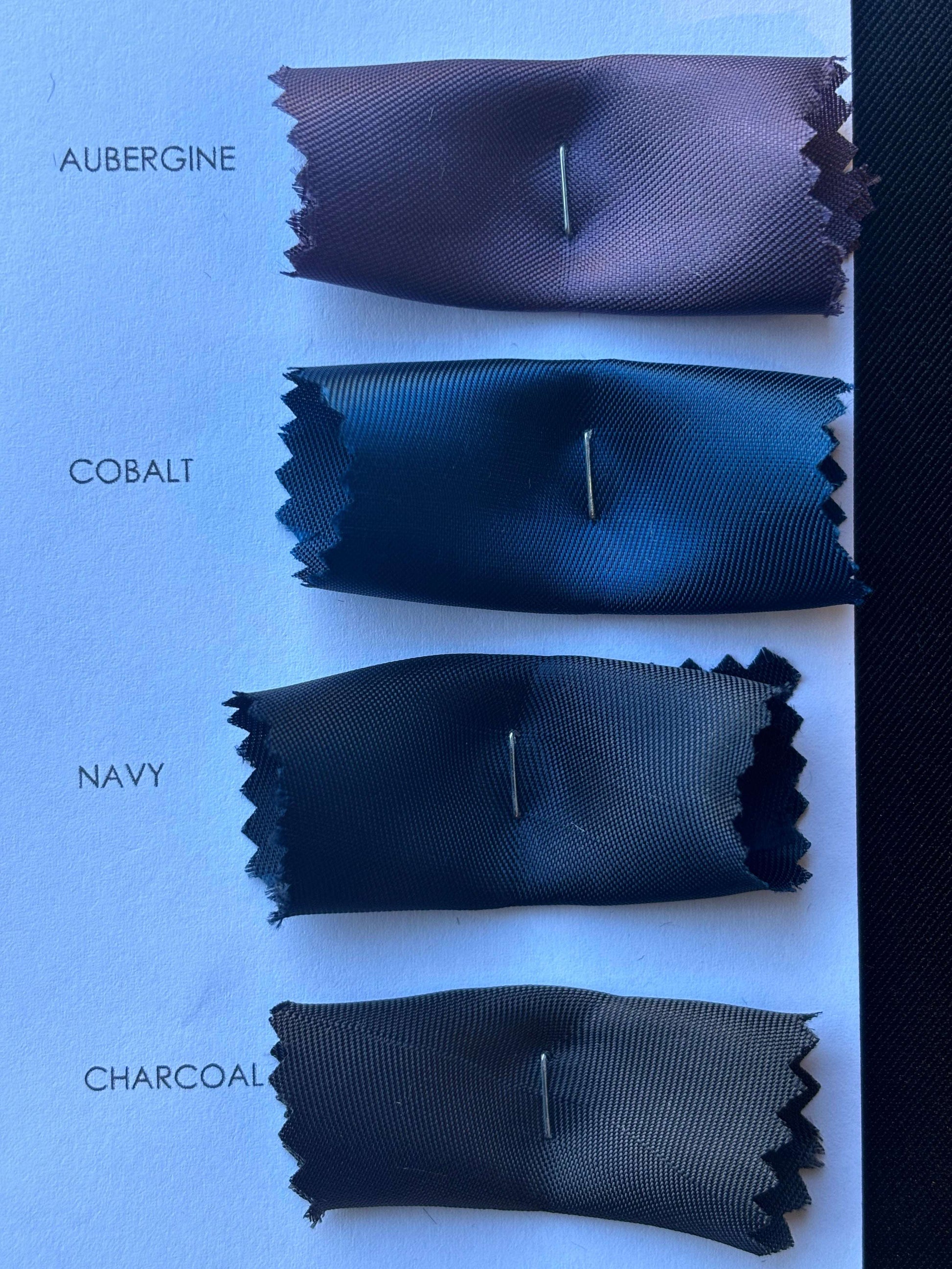 Showing another closeup of the Saga color card swatches with auberine, cobalt, navy and charcoal