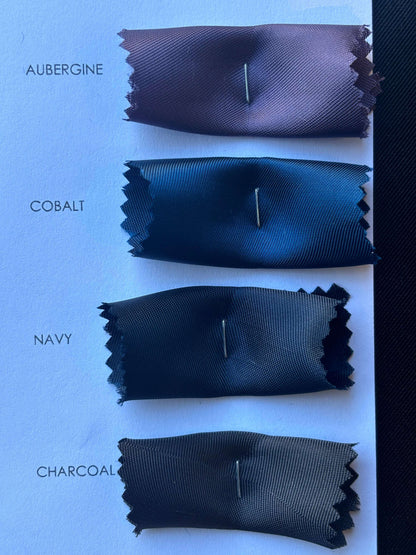 Showing another closeup of the Saga color card swatches with auberine, cobalt, navy and charcoal