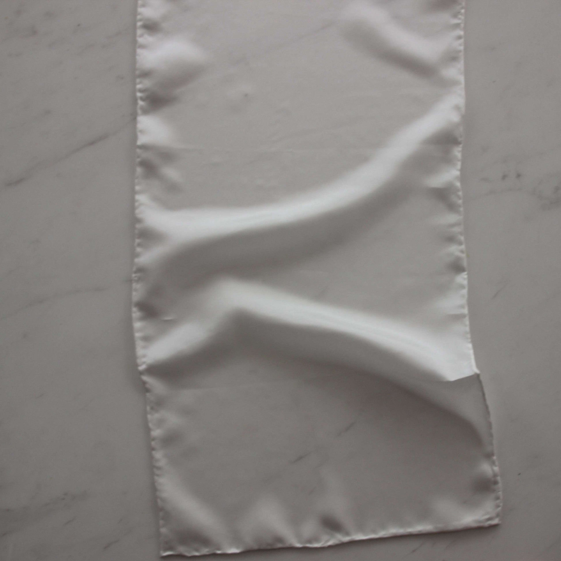 Presenting pajeant scarf featuring a natural colored soft feather weight pure silk 28cm x 160cm with rolled edge and floaty fluid drape