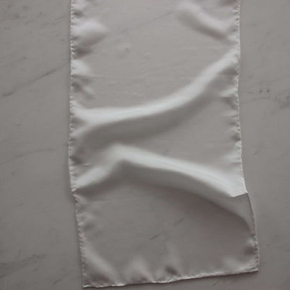 Presenting pajeant scarf featuring a natural colored soft feather weight pure silk 28cm x 160cm with rolled edge and floaty fluid drape