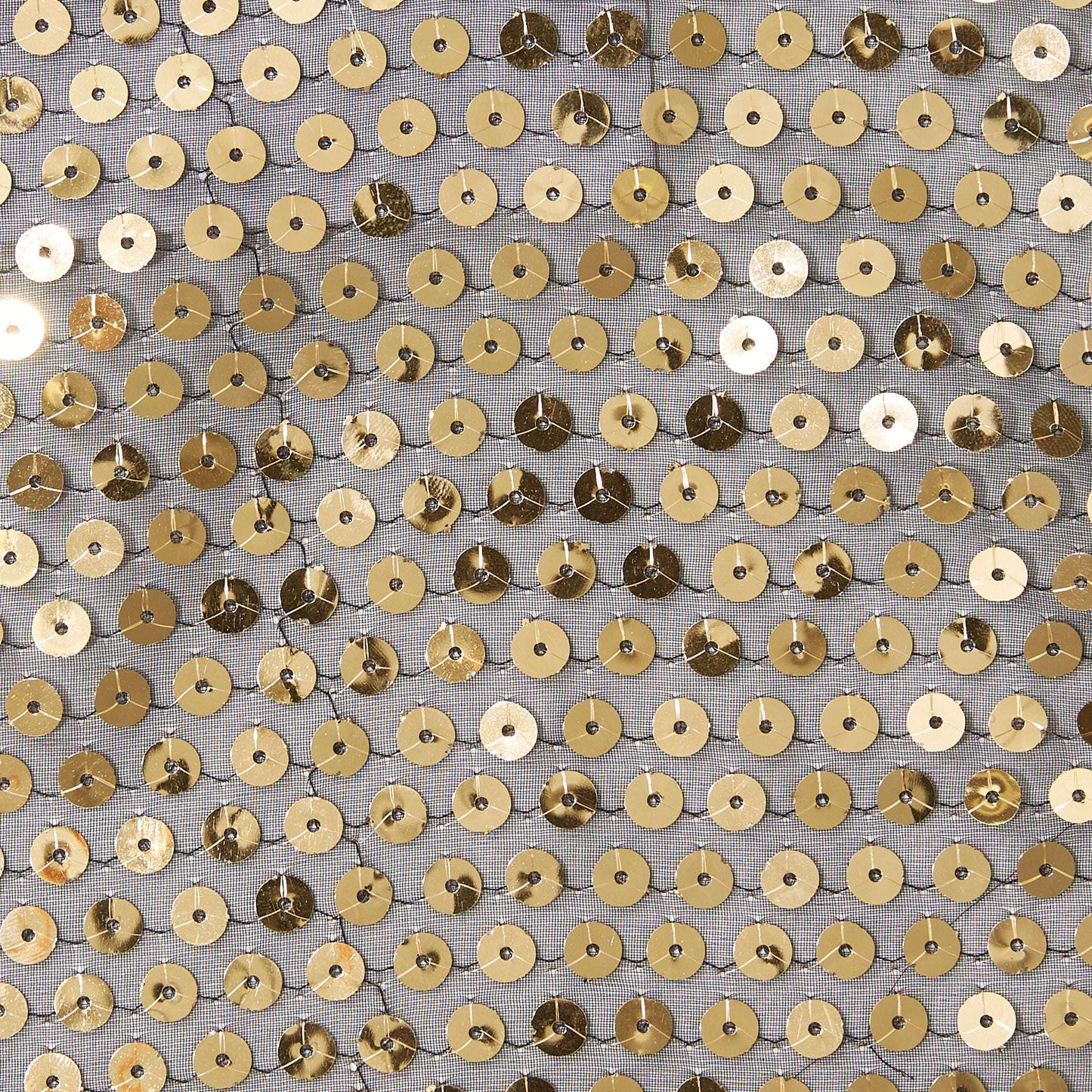 Showing sequin georgette featuring Gold colored sequins on sheer georgette polyester black mesh with good drape